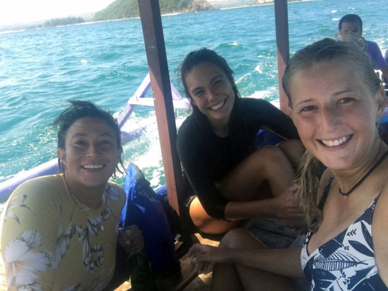 surfer girls of the we wave Surf camp driving with the boat to gerupuk inside